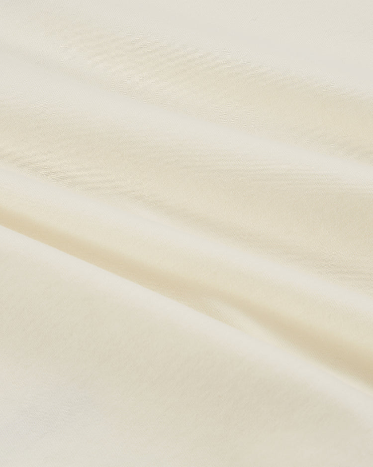Close-up of soft, cream-colored cotton on the Los Angeles Aztecs Vintage Collar Soccer Jersey by Ebbets Field, featuring gentle folds and a smooth, lightly textured surface—ideal for vintage-inspired style and comfort.