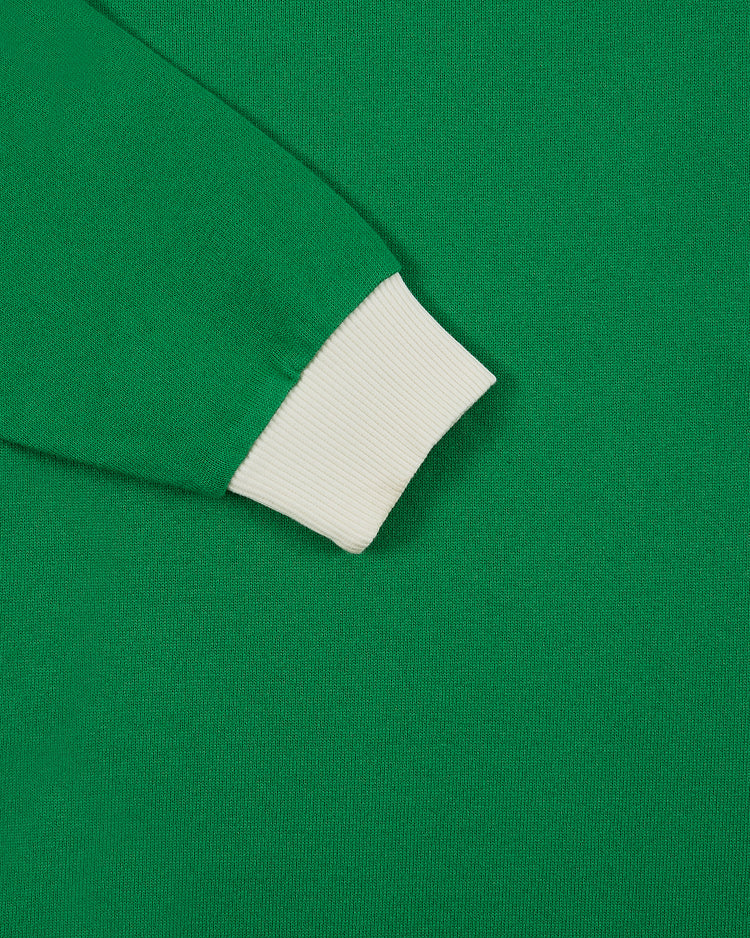 Close-up of the Ebbets Field New York Cosmos Vintage Soccer Goalie Jersey, a green knit long sleeve with a contrasting white ribbed cuff adding texture and classic goalkeeper style.