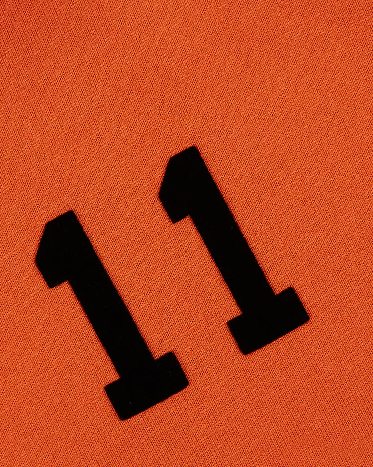 The Ebbets Field Los Angeles Aztecs Vintage Soccer Goalie Jersey features a black number 11 on an orange fabric, inspired by classic long sleeve soccer jerseys.