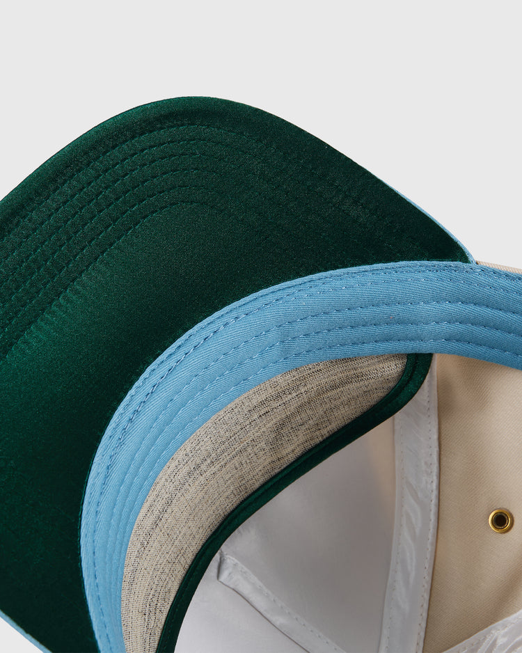 Close-up of two overlapping Ebbets Field Dallas Tornados A-Frame Cotton Twill Ballcaps—one with a dark green brim and one with a light blue brim—highlighting their vintage style and inner linings for NASL fans.