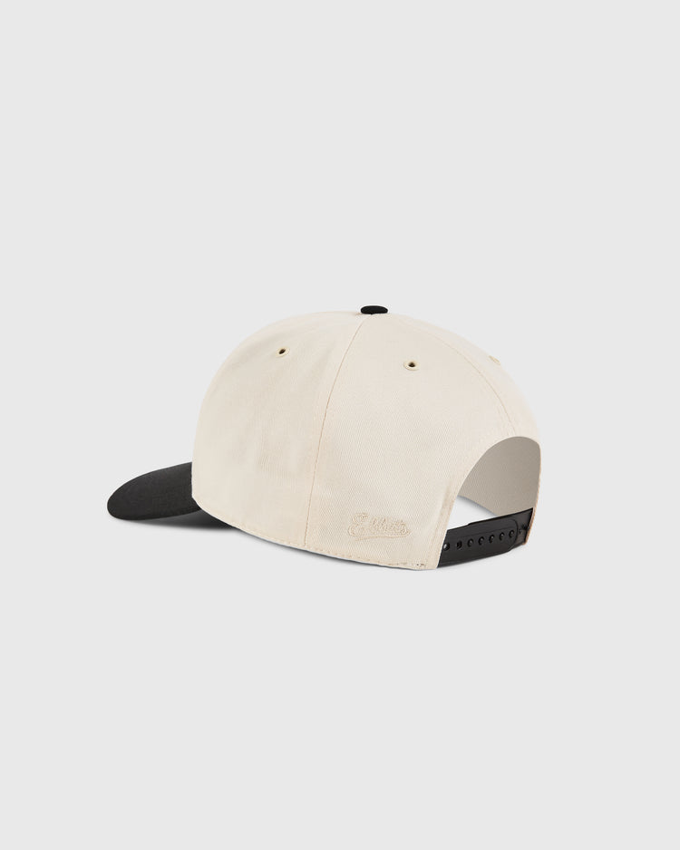 The Detroit Cougars A-Frame Cotton Twill Ballcap by Ebbets Field is a cream retro cap with a black brim, adjustable black snapback closure, and subtle embroidered side text, shown here from the back.