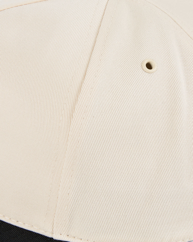 Close-up of the Ebbets Field Detroit Cougars A-Frame Cotton Twill Ballcap, highlighting beige fabric, detailed stitching, and a small metal ventilation eyelet near the crown.