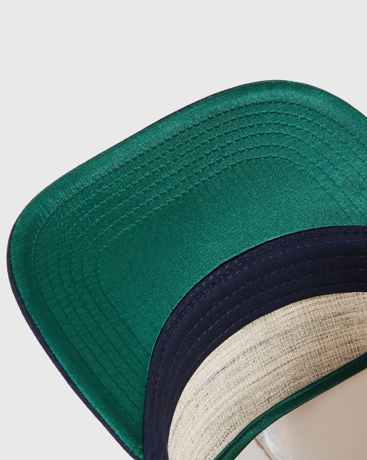 A close-up of the New Jersey Americans A-Frame Cotton Twill Ballcap by Ebbets Field highlights the detailed stitching on its green brim and contrasting navy blue edge.