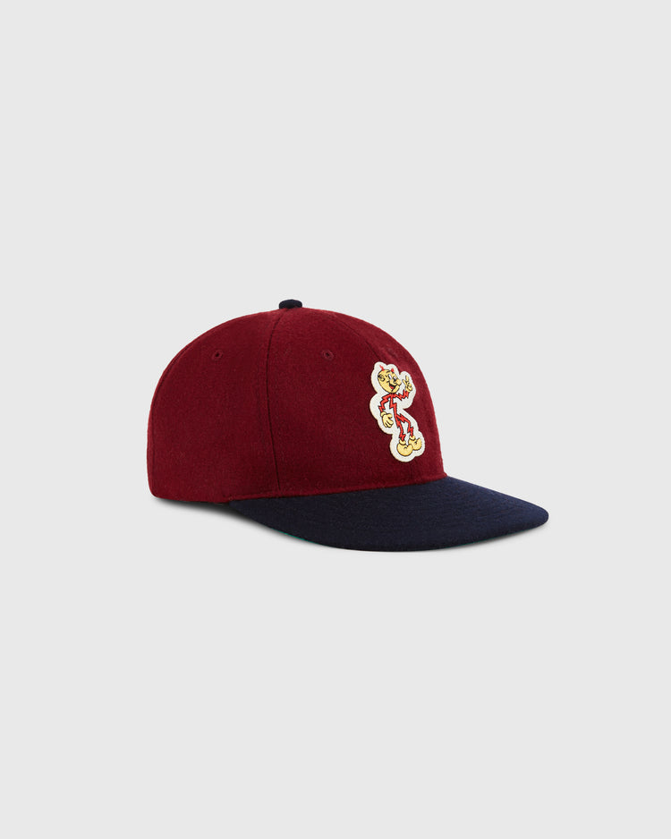 The Ebbets Field Reddy Kilowatt 1940 Wool Ballcap for kids in maroon with a navy brim and a cartoon mascot patch with 