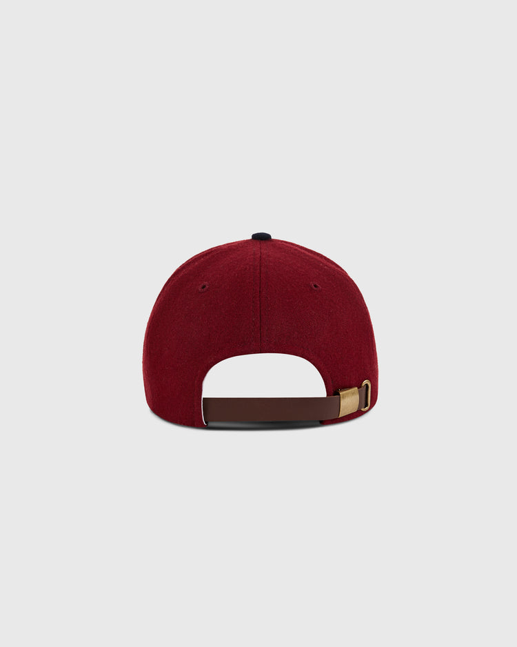 The Ebbets Field Reddy Kilowatt 1940 Wool Ballcap for kids is shown from the back, highlighting its adjustable brown leather strap with a gold buckle, set against a plain light gray background.