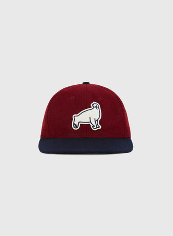 The Ebbets Field San Francisco Seals 1940 Wool Ballcap features burgundy wool, a navy brim, and a white embroidered sea lion patch, inspired by the historic team. Shown here against a plain light gray background.