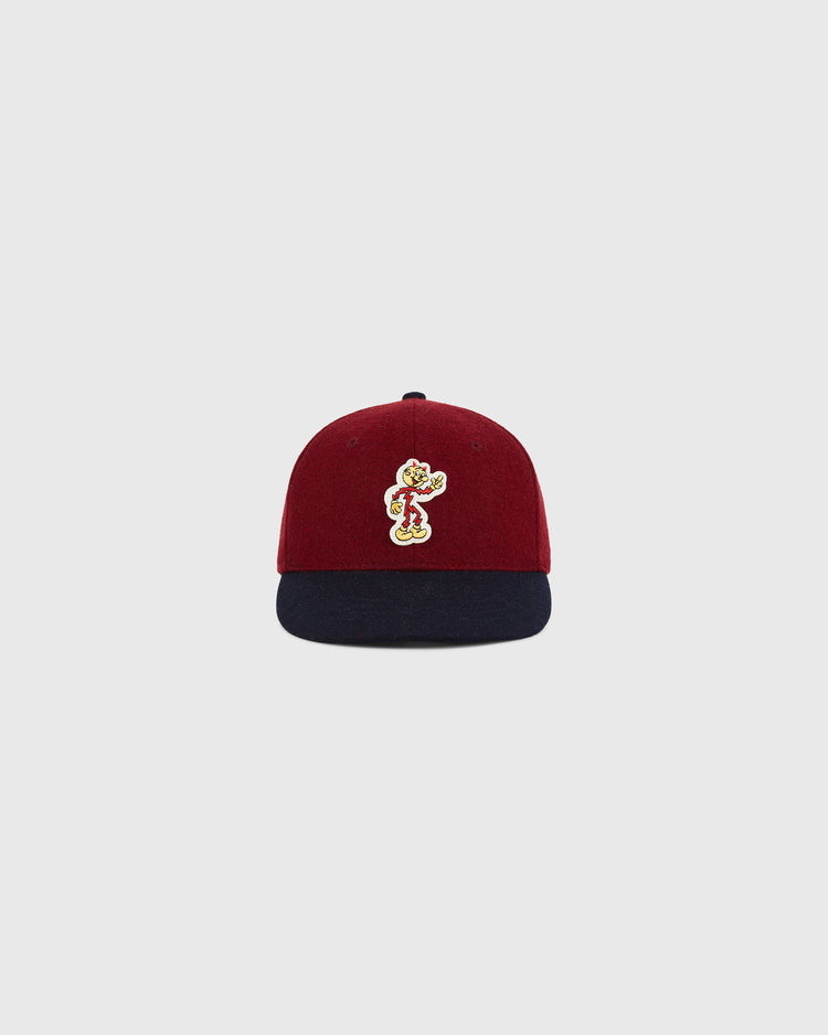 The Ebbets Field Red Reddy K 1940 Authentic Ballcap is a maroon cap with a navy brim and a vibrant embroidered cartoon character on the front, displayed on a plain light gray background.