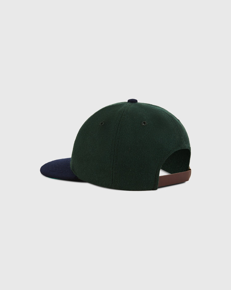 The Ebbets Field Los Angeles Angels (PCL) 1949 Wool Ballcap features dark green wool, a navy brim, and a brown adjustable strap, displayed on a plain light background.
