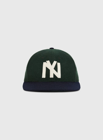 The Ebbets Field Brooklyn Eagles 1935 Wool Ballcap (Youth Size) features green wool, a navy brim, and a large white NY logo inspired by classic Negro Leagues hats, shown on a plain light gray background.