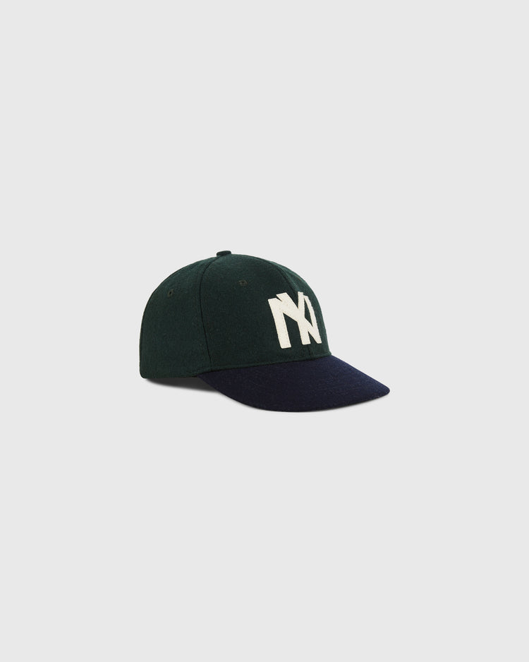 The Ebbets Field BK Eagles 1935 Authentic Ballcap is a dark green cap with a navy brim and bold white NY letters on the front, shown against a plain light background.