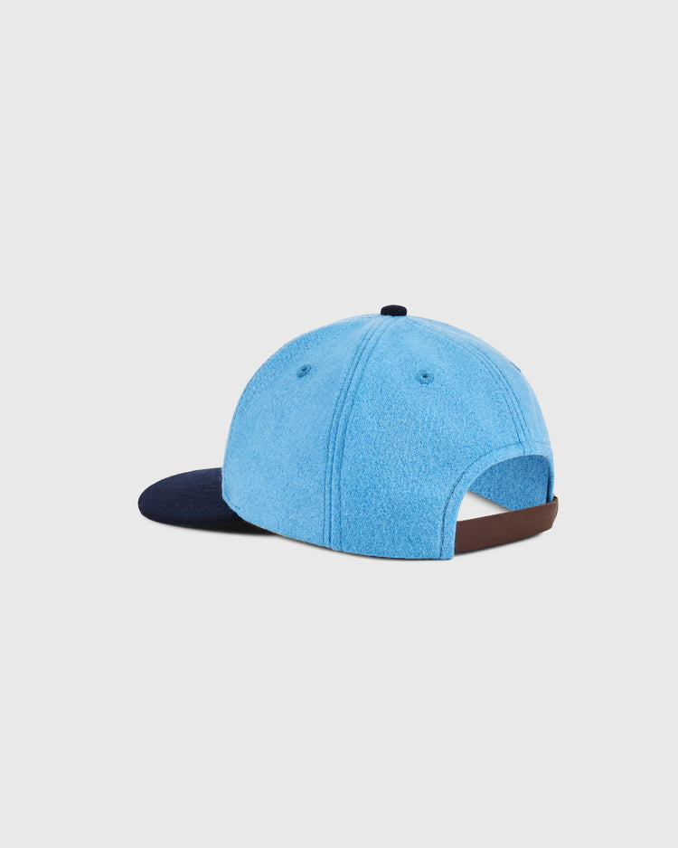 The Ebbets Field Santurce Cangrejeros Crab Wool Ballcap features a light blue wool body, dark navy brim, brown adjustable strap, and top button, inspired by classic Puerto Rican baseball style. Shown from the back against a white background.