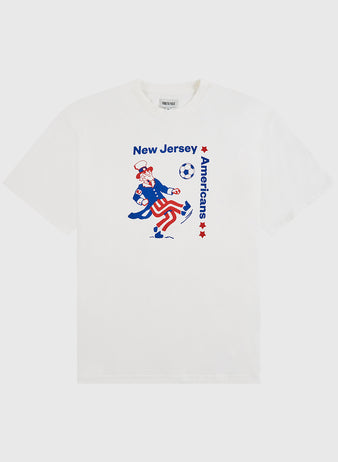Show your love for American soccer with the Ebbets Field New Jersey Americans Short Sleeve Graphic T-Shirt—featuring Uncle Sam kicking a soccer ball and blue and red stars on a classic white tee.