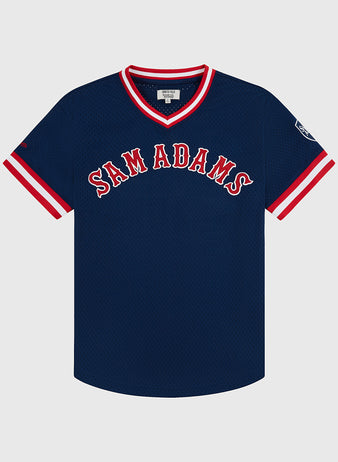 The Sam Adams Mesh V-Neck Jersey by Ebbets Field features navy blue vintage mesh, bold white and red SAM ADAMS lettering, striped cuffs and collar, and a small patch on the left sleeve.