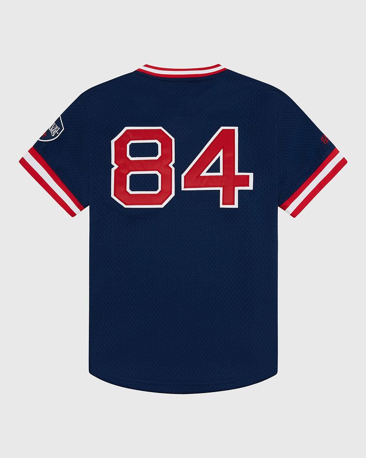 The Sam Adams Mesh V-Neck Jersey by Ebbets Field features navy blue mesh, red and white striped sleeves and collar, a large red 84 with white outline on the back, and a small Ebbets Field patch on the left sleeve.