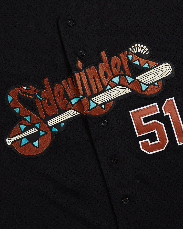 Introducing the Ebbets Field Randy Johnson Tucson Sidewinders Button Up Mesh Jersey: a black jersey featuring 