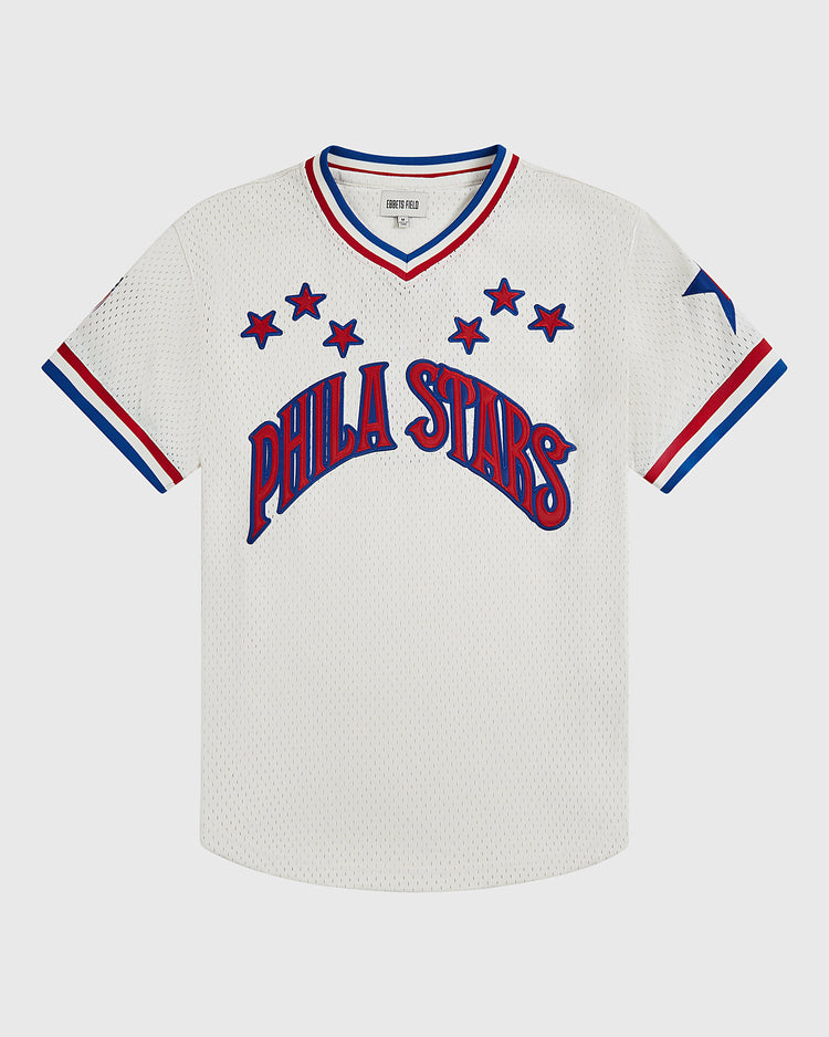 The Ebbets Field Philadelphia Stars V-Neck Mesh Jersey features a white mesh design with PHILA STARS in blue and red across the front, complemented by red and blue trim on the sleeves and collar, plus blue stars surrounding the text and on the left sleeve—honoring the classic Negro National League jersey style.
