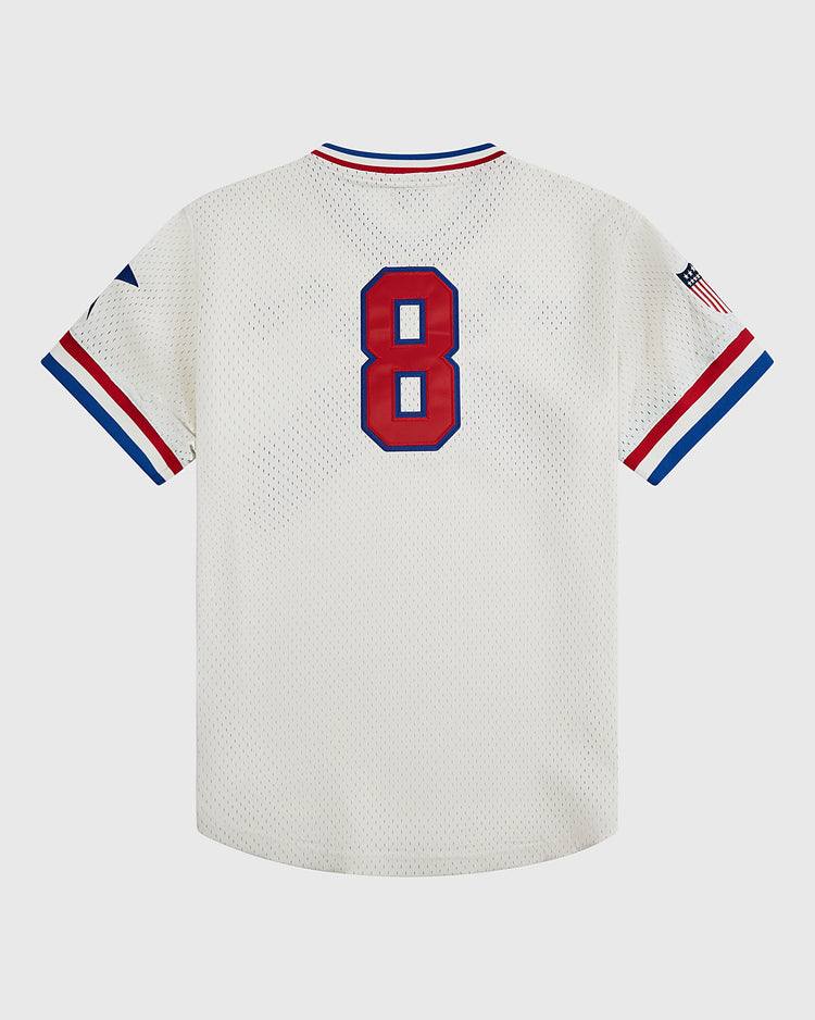 The Ebbets Field Philadelphia Stars V-Neck Mesh Jersey features a breathable white mesh construction with blue and red trim, a bold red number 8 on the back, and an American flag patch on the right sleeve—capturing the timeless look of a classic Philadelphia Stars uniform.
