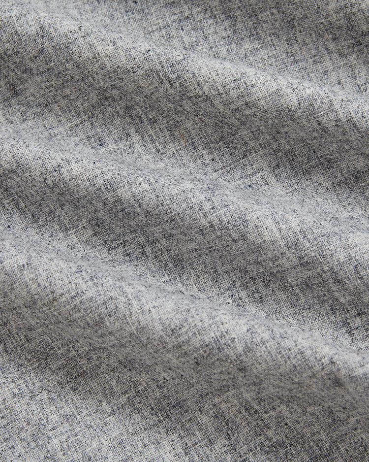 Close-up of light gray, slightly wrinkled fabric with a soft, heathered texture and subtle shadows highlighting the weave and folds—capturing the authentic look and feel of the Ebbets Field Philadelphia Stars 1939 Wool Authentic Road Jersey, inspired by classic sportswear.