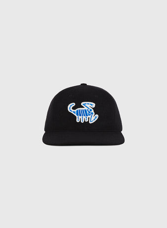The Almendares Alacranes 1948 Authentic Wool Ballcap by Ebbets Field is a black baseball cap with a blue and white embroidered dinosaur skeleton design on the front, displayed against a plain light gray background.
