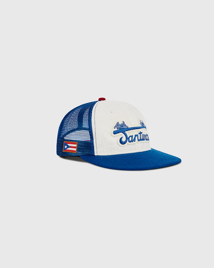 The Ebbets Field Santurce Wool Mesh Trucker Ballcap features a blue and white design with 