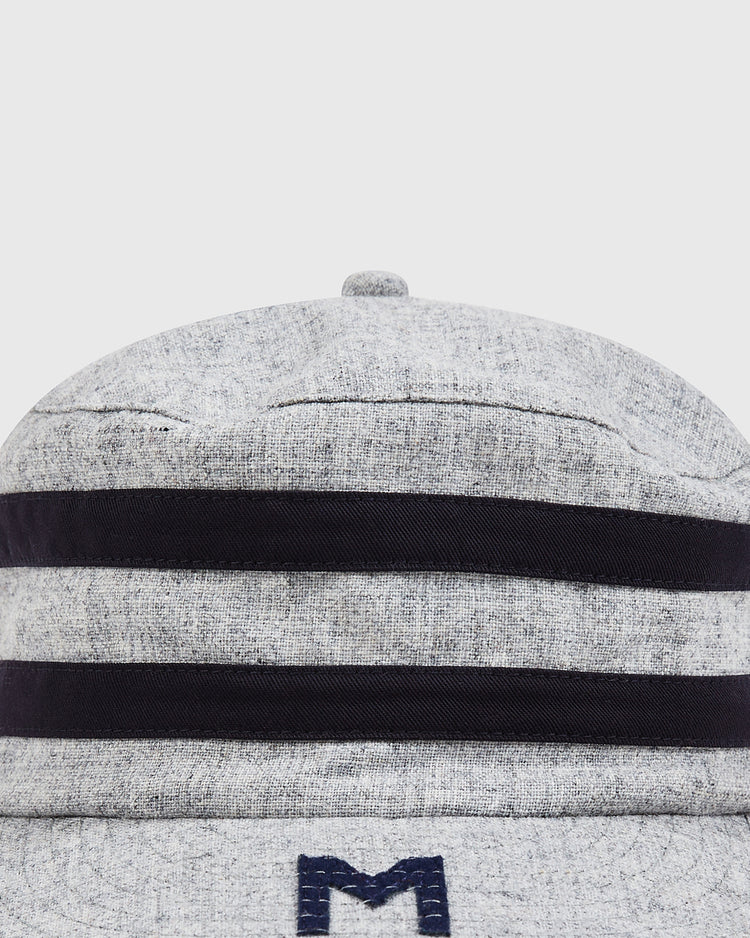 A close-up of the Ebbets Field Milwaukee Brewers (AA) 1905 Pillbox Cap, a vintage-style wool cap in gray with two bold black horizontal stripes and a partial blue embroidered “M” at the bottom—a classic tribute to Milwaukee Brewers heritage.