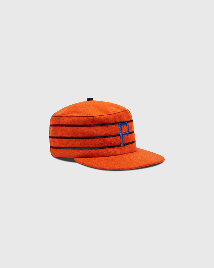 An authentic reproduction of the 1983 Phoenix Giants pillbox cap by Ebbets Field, featuring orange fabric with three black horizontal stripes and a blue “P” on the front, displayed against a plain light gray background.