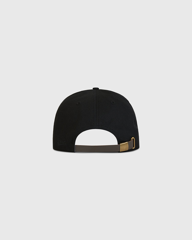 An image of the Ebbets Field Tokyo Giants Patch Cotton Twill Ballcap in black, shown from the back with an adjustable brown strap and brass buckle, featuring a small button on top, set against a plain light gray background.