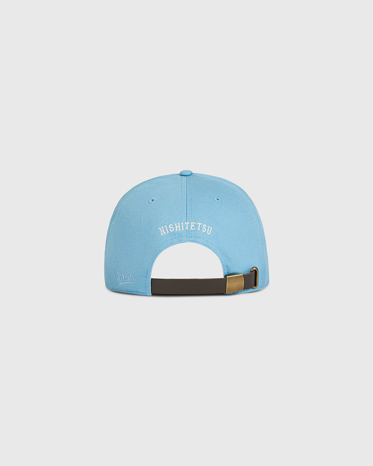 An Ebbets Field Nishitetsu Lions 1971 Cotton Twill Ballcap in light blue, shown from the back with “NISHITETSU” embroidered in white and an adjustable black strap with a brass clasp, echoing the vintage style of the 1971 Nishitetsu Lions.