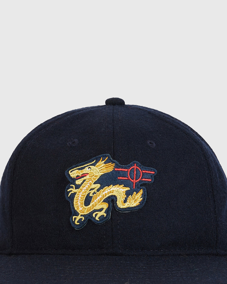 The Ebbets Field Chunichi Dragons 1969 Logo Wool Ballcap is a navy blue authentic wool cap featuring an embroidered yellow dragon with red accents on the front, reminiscent of a classic Chunichi Dragons ballcap.