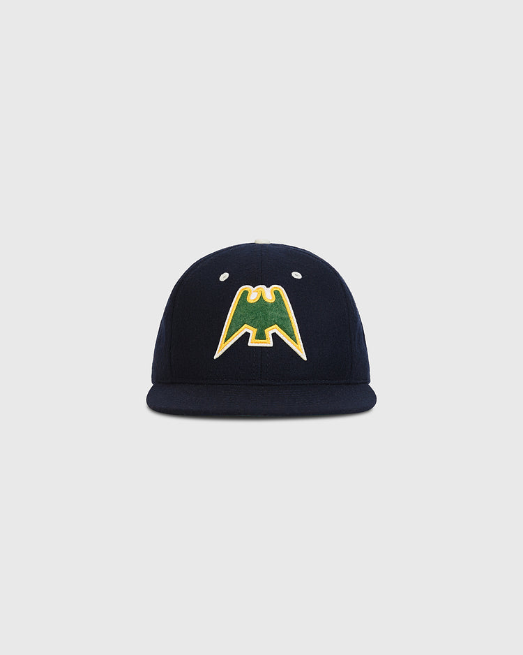 The Ebbets Field Nankai Hawks 1950 Authentic Wool Ballcap, crafted in navy blue wool and adorned with a yellow and green bat-shaped logo on the front, evokes classic Japanese baseball style and is showcased against a plain light gray background.
