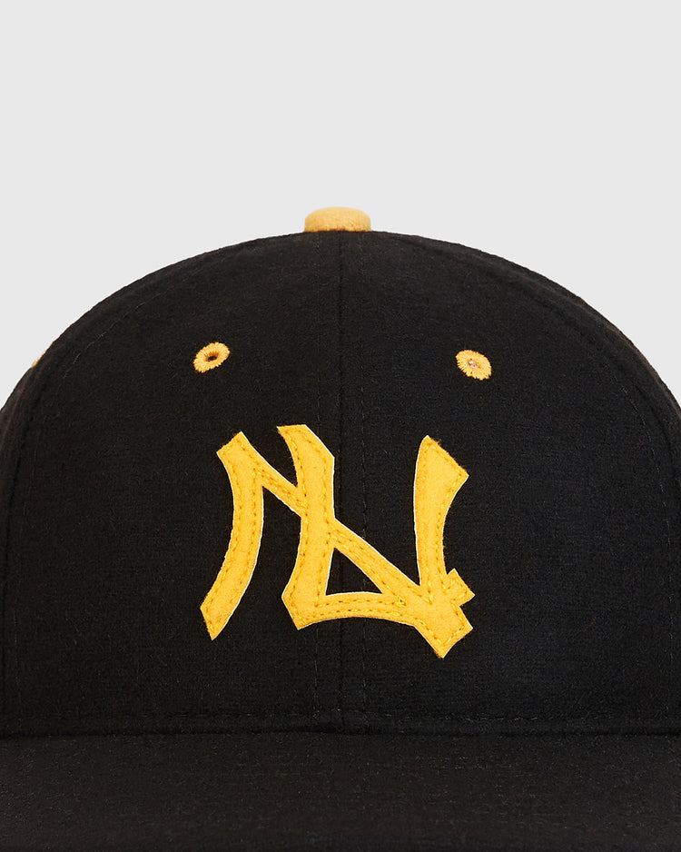 The Ebbets Field Nishitetsu Lion 1971 Authentic Wool Ballcap is crafted from black wool and features yellow embroidered lettering in a stylized font on the front, accented with yellow eyelets and a top button—drawing inspiration from the classic Fukuoka-era 1971 Nishitetsu Lions.
