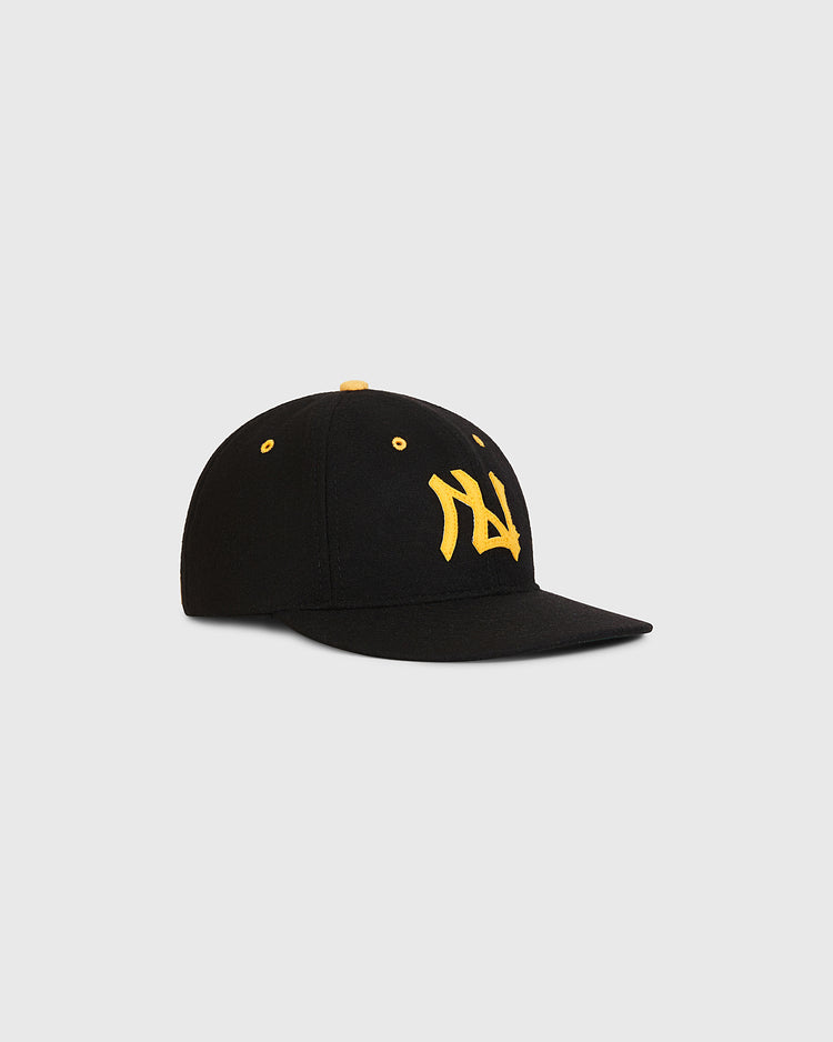 The Ebbets Field Nishitetsu Lion 1971 Authentic Wool Ballcap, featuring black wool construction, yellow ventilation holes, and a yellow embroidered front logo inspired by the Fukuoka era 1971 Nishitetsu Lions, is displayed on a plain light background.