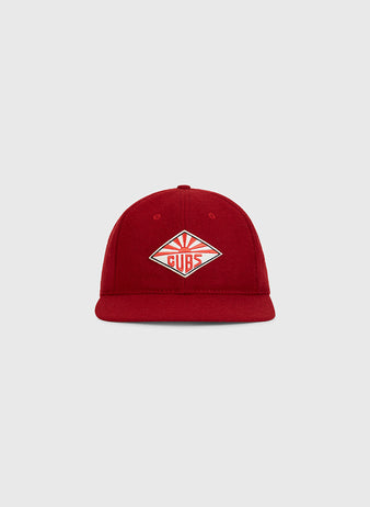 The Taiyo Cubs 1928 Authentic Wool Ballcap by Ebbets Field is a red cap displayed on a light gray background, featuring a diamond-shaped patch with “Cubs” and stylized sun rays on the front.