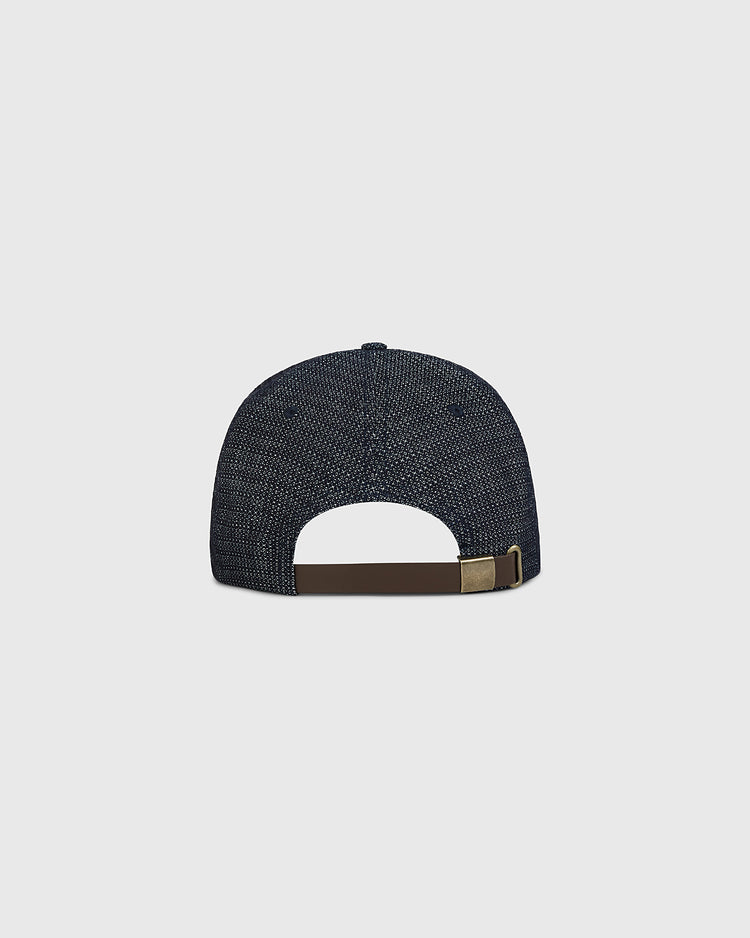 Back view of the Ebbets Field Osaka Tigers Japanese Indigo Cotton Dobby Ballcap, showcasing its indigo-dyed textured finish inspired by Japanese baseball, with a brown adjustable strap and gold buckle, set against a plain light gray background.