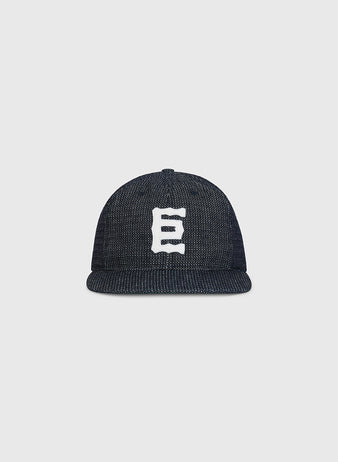An Ebbets Field Tokyo Giants 1940 Japanese Indigo Cotton Ballcap, featuring a white, stylized letter E on the front, is displayed against a plain light gray background.
