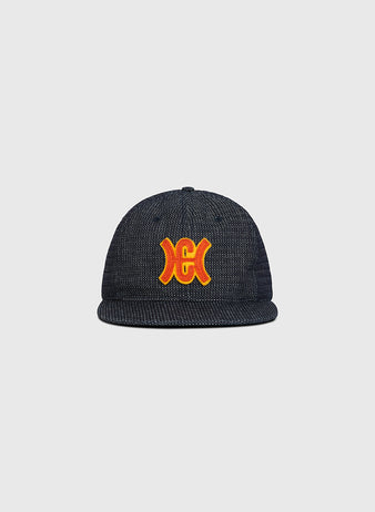 The Ebbets Field Hiroshima Carp Japanese Indigo Cotton Dobby Ballcap—a premium ballcap crafted from Japanese indigo-dyed cotton dobby and showcasing a striking red and yellow embroidered Hiroshima Carp logo on the front—is displayed against a plain light gray background.