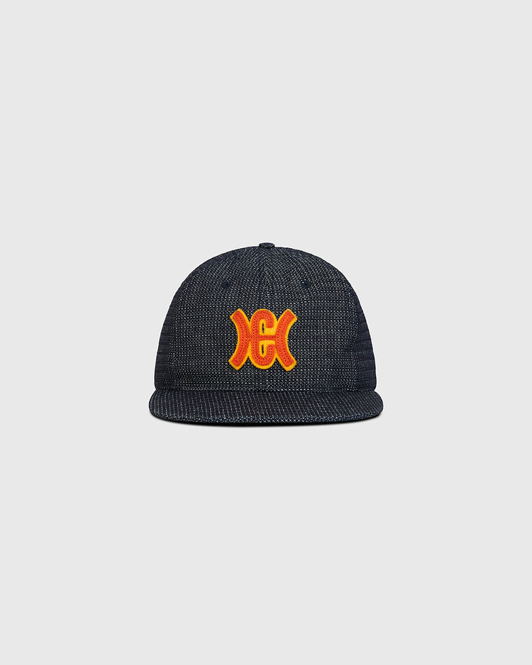 The Ebbets Field Hiroshima Carp Japanese Indigo Cotton Dobby Ballcap—a premium ballcap crafted from Japanese indigo-dyed cotton dobby and showcasing a striking red and yellow embroidered Hiroshima Carp logo on the front—is displayed against a plain light gray background.