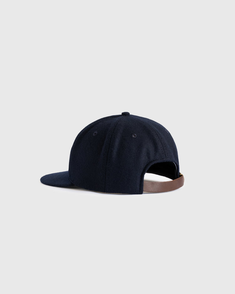 The EFF San Francisco Mission Reds 1937 Authentic Wool Ballcap, in navy with a curved brim and adjustable brown leather strap, is styled as a vintage reproduction and shown on a plain light gray background.