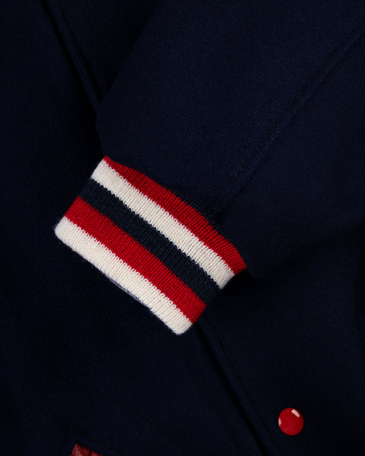 A close-up of the EFF St. Louis Cardinals 1950 Authentic All Wool Varsity Jacket sleeve shows a ribbed cuff with red, white, and navy stripes and a red button near the cuff, highlighting this classic replica.