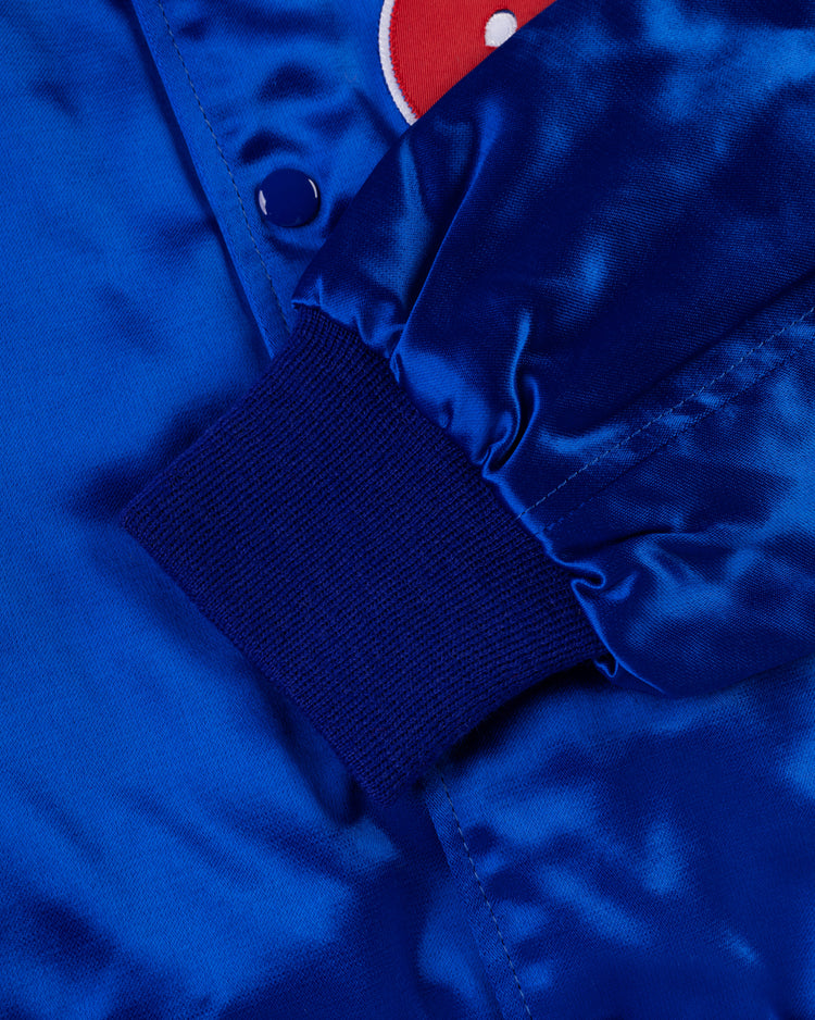 Close-up of the EFF Montreal Expos 1969 Authentic All Satin Varsity Jacket in shiny royal blue, featuring a snap button, ribbed cuff, and a visible red and white patch for classic vintage baseball style.