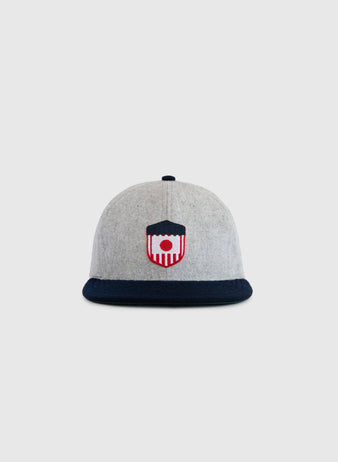 The EFF U.S. Tour of Japan 1922 Authentic Wool Ballcap features a grey crown, dark navy brim, and embroidered red, white, and navy shield emblem on the front, displayed against a plain light background.