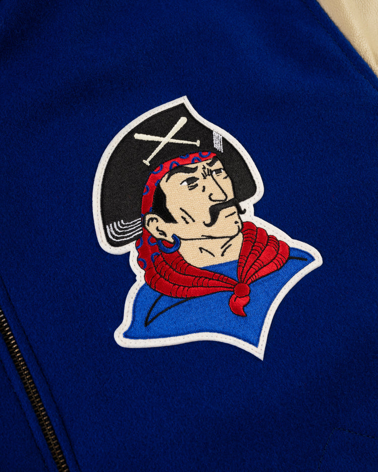 The EFF Pittsburgh Pirates 1945 Authentic Wool & Leather Varsity Jacket in royal blue features a close-up of an embroidered pirate head patch with a black hat, white crossbones, red scarf, and a partially visible black zipper.