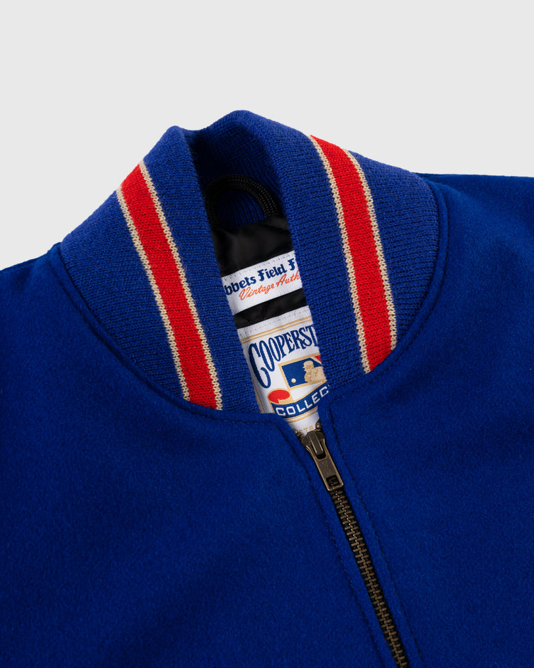 Close-up of the Pittsburgh Pirates 1945 Authentic Wool & Leather Varsity Jacket by EFF, showing a ribbed collar with red and white stripes and a partially zipped front that reveals the Cooperstown Collection label inside.