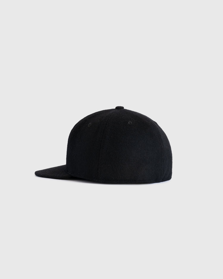 The EFF Bismarck Churchills 1935 Authentic Wool Softbrim Ballcap in black is shown from the side on a light gray background, featuring a flat brim and no visible logos, reflecting its classic 1935 replica style.