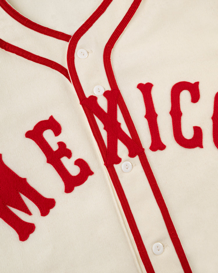 A close-up of the EFF Mexico City Red Devils 1957 Authentic Wool Home Jersey features red trim, 