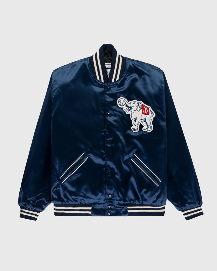 The EFF Philadelphia Athletics 1953 Authentic All Satin Varsity Jacket is navy blue with white striped cuffs, collar, and hem. It sports a white elephant patch with red A’s logo on the chest and two front pockets, honoring classic Athletics style.