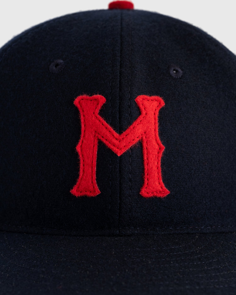 A close-up of the EFF Minneapolis Millers 1938 Authentic Wool Ballcap in dark blue, featuring a bold red M on the front, just like Ted Williams wore.