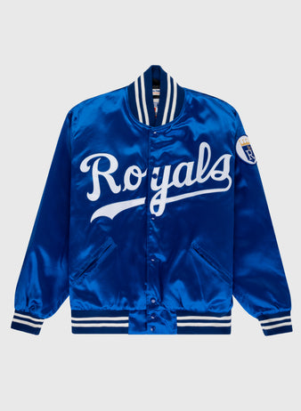 The EFF Kansas City Royals 1969 Authentic All Satin Varsity Jacket features royal blue satin, white Royals script on the front, striped ribbed trim, and a sleeve patch inspired by the original 1969 Royals jacket.