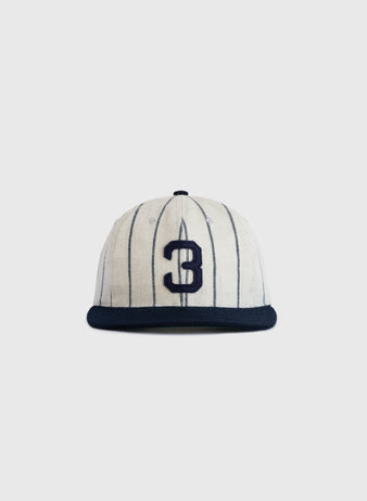 The Ebbets Field Flannels Babe Ruth 1932 Signature Series Wool Ballcap features thin vertical navy stripes, a bold navy number 3 on the front, and a solid navy brim, capturing classic Yankees style against a simple light background.