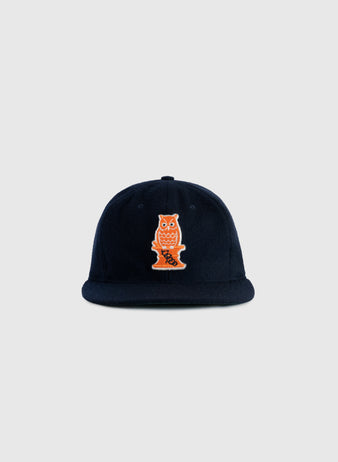 The EFF Owl Drug 1941 Authentic Wool Ballcap is a navy blue cap with an orange and white embroidered Owl logo, inspired by the historic Bay Area semi-pro team, shown against a plain light gray background.